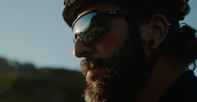 a man with a beard wearing a helmet and sunglasses