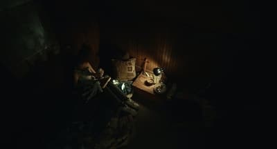a couple of people sitting in a dark room