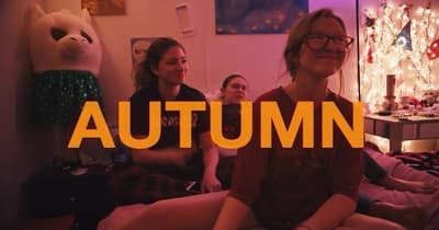 a group of people sitting on a bed in a room