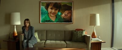 a woman sitting on a couch in a living room