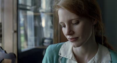 a woman looking down at her cell phone