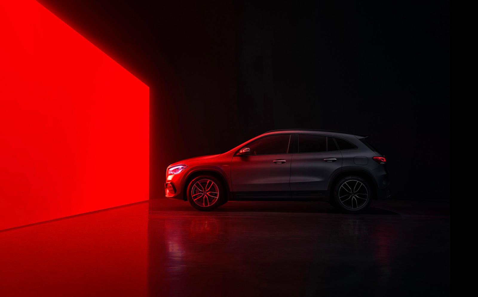 a car parked in front of a red wall