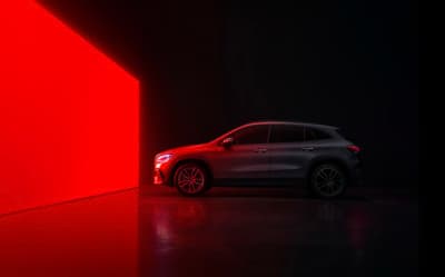 a car parked in front of a red wall