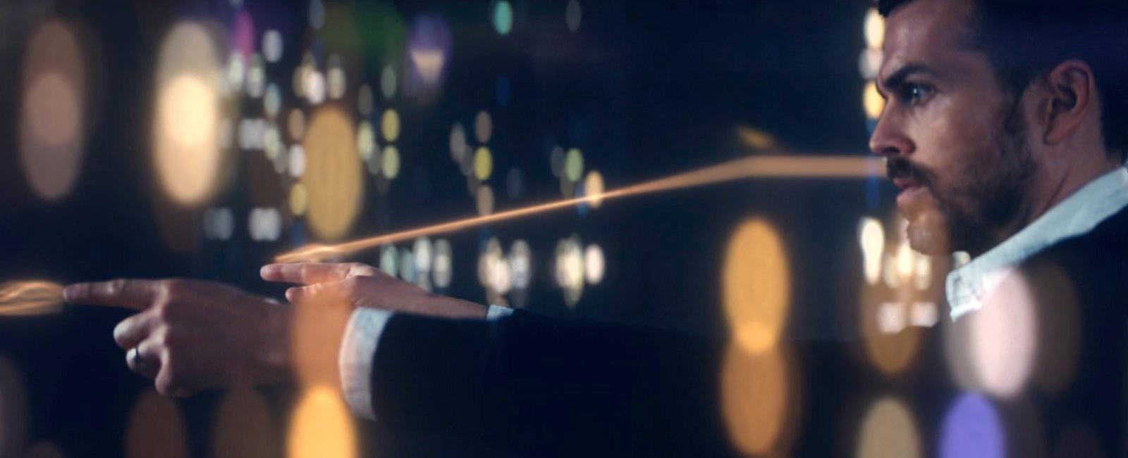 a man holding a wand in his right hand