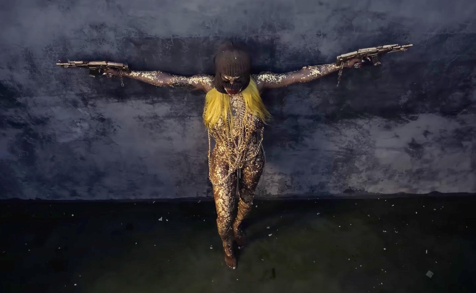 a woman with her arms spread out in front of a dark background
