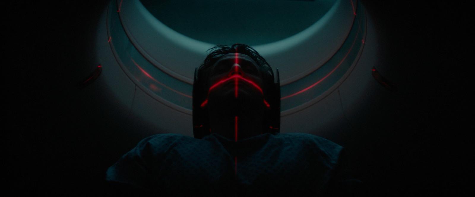 a person in a dark room with a red light on their face