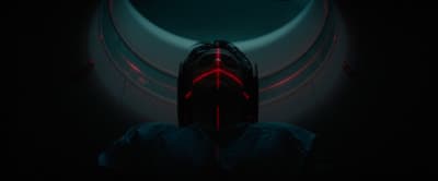 a person in a dark room with a red light on their face