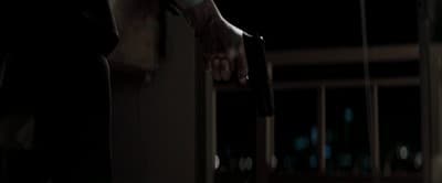 a person holding onto a door handle in the dark