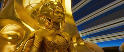 a gold statue of a woman in a golden outfit