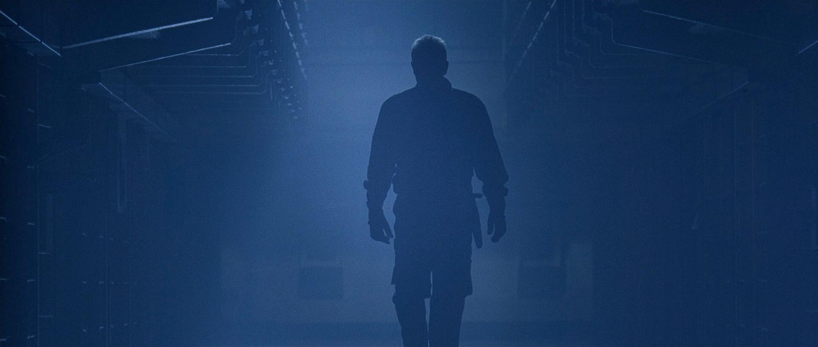 a man standing alone in a dark room