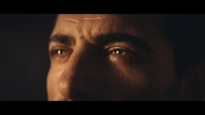 a close up of a man's face in the dark