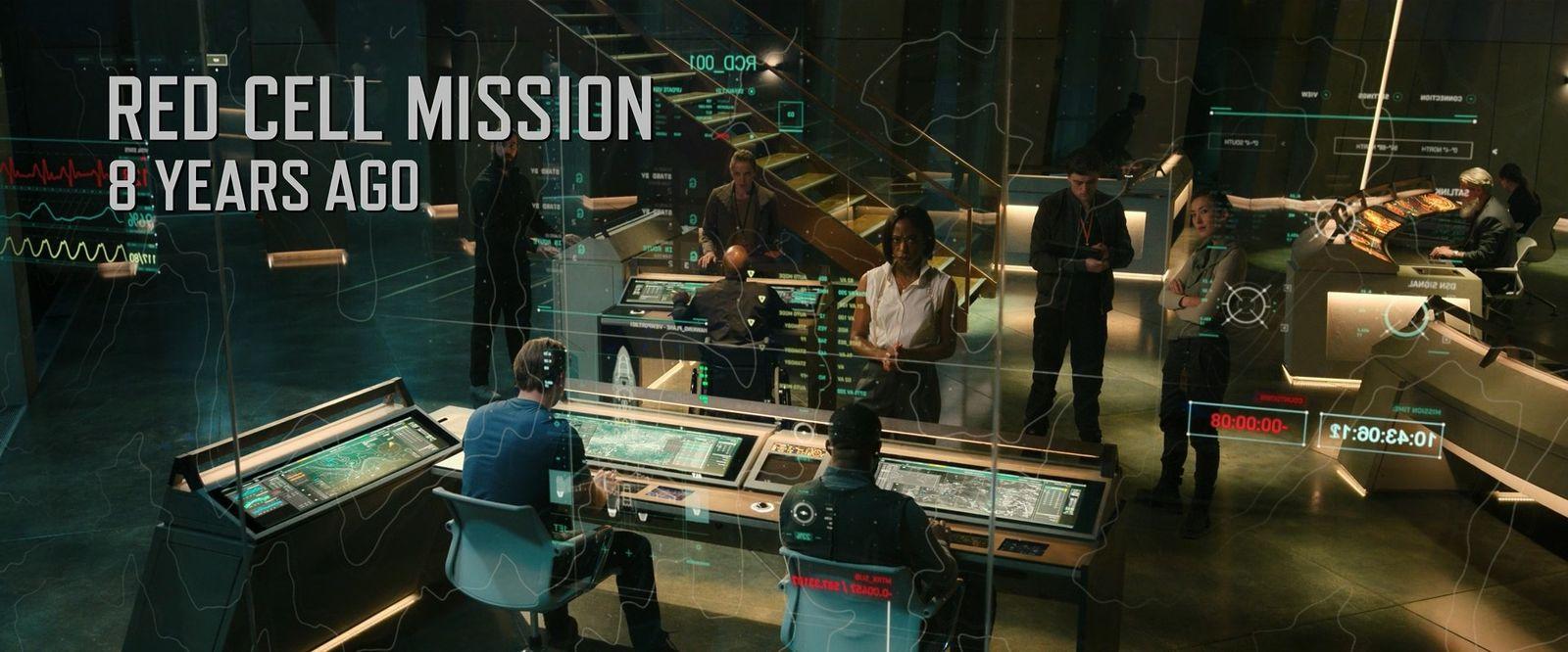 a group of people standing around a control room