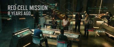 a group of people standing around a control room