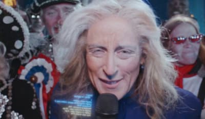a woman with a microphone in front of a group of people
