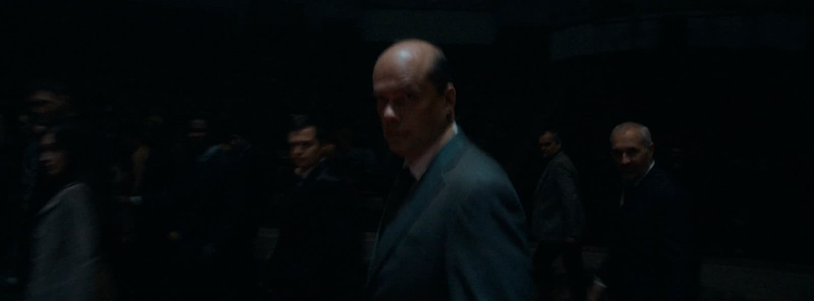 a group of people standing in a dark room
