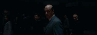 a group of people standing in a dark room