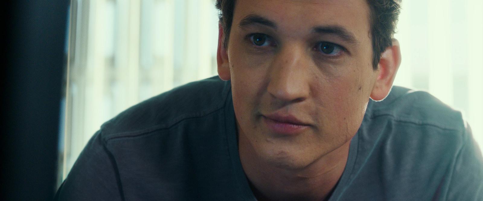 a close up of a person wearing a gray shirt