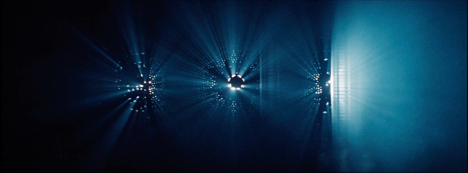 a dark room with a light shining through the window