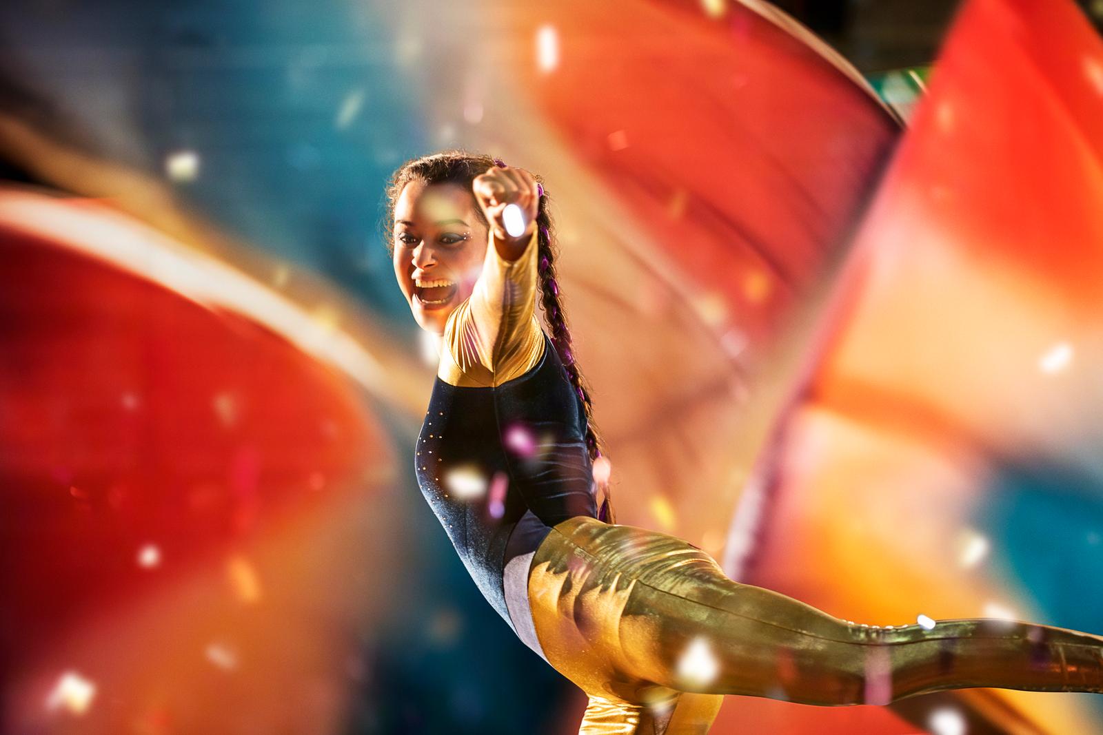 a woman is doing a trick on a surfboard