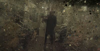 a person standing in a dark room with lots of debris