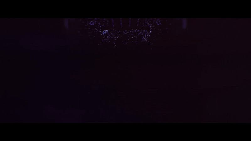 a dark room with a clock on the wall