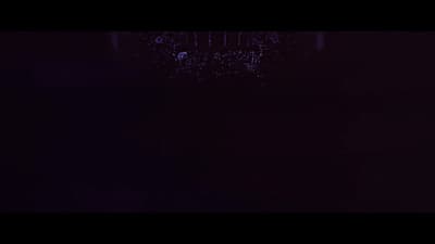 a dark room with a clock on the wall