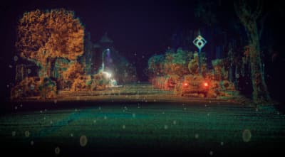 a night scene of a street with a clock tower in the distance