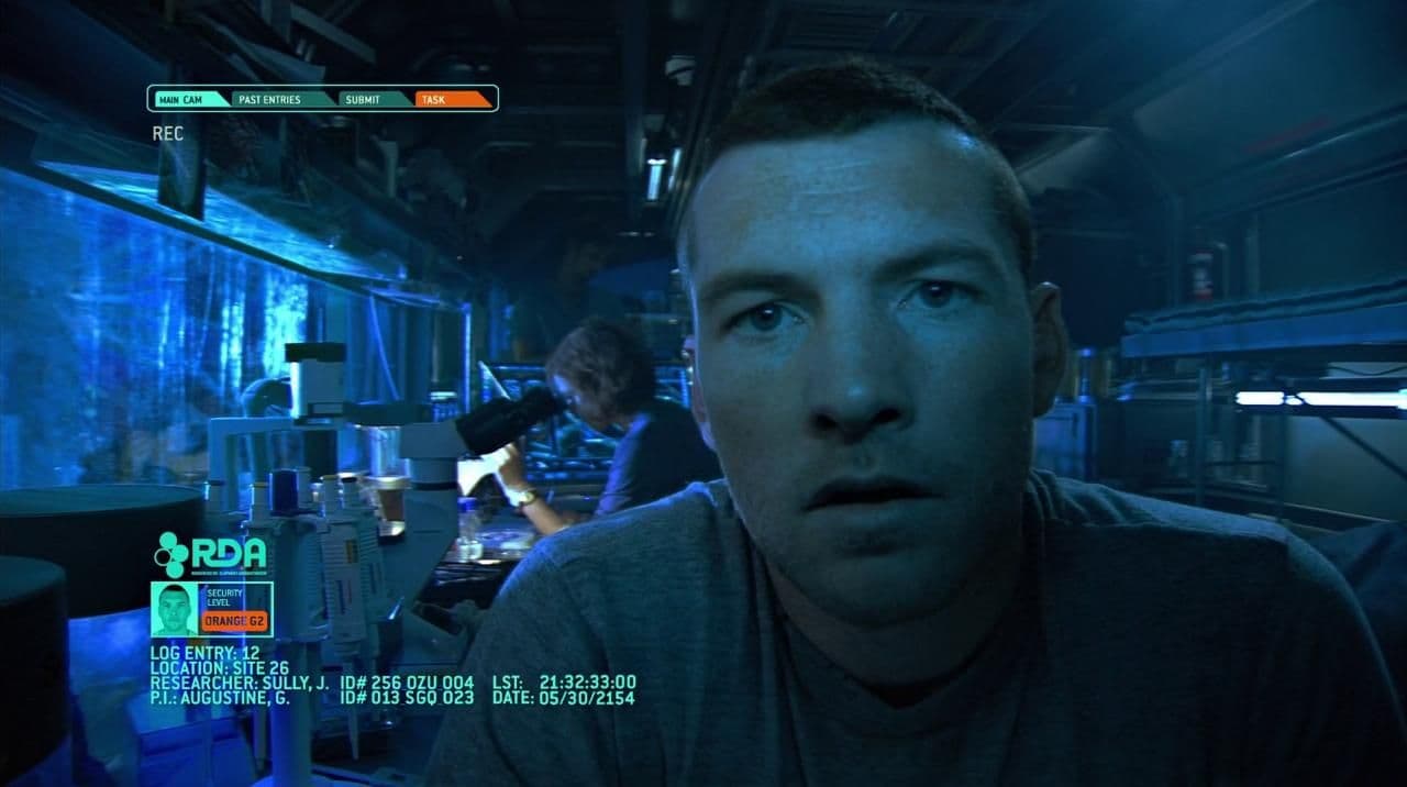 a man in a dark room looking at the camera