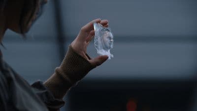 a person holding a plastic object in their hand