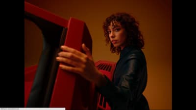a woman holding a red object in her hands