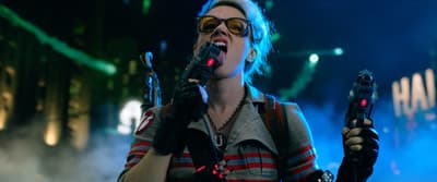a woman singing into a microphone on stage