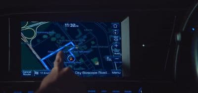 a person using a gps device in a car