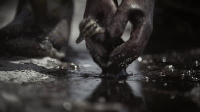 a close up of a person's hands in the water