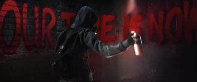 a person in a hooded jacket holding a flashlight
