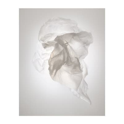 a piece of white tissue sitting on top of a table