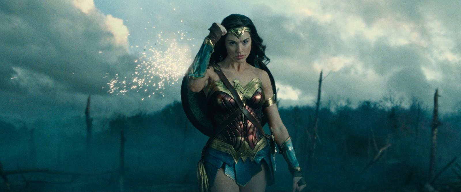 a woman dressed as wonder is holding a sparkler