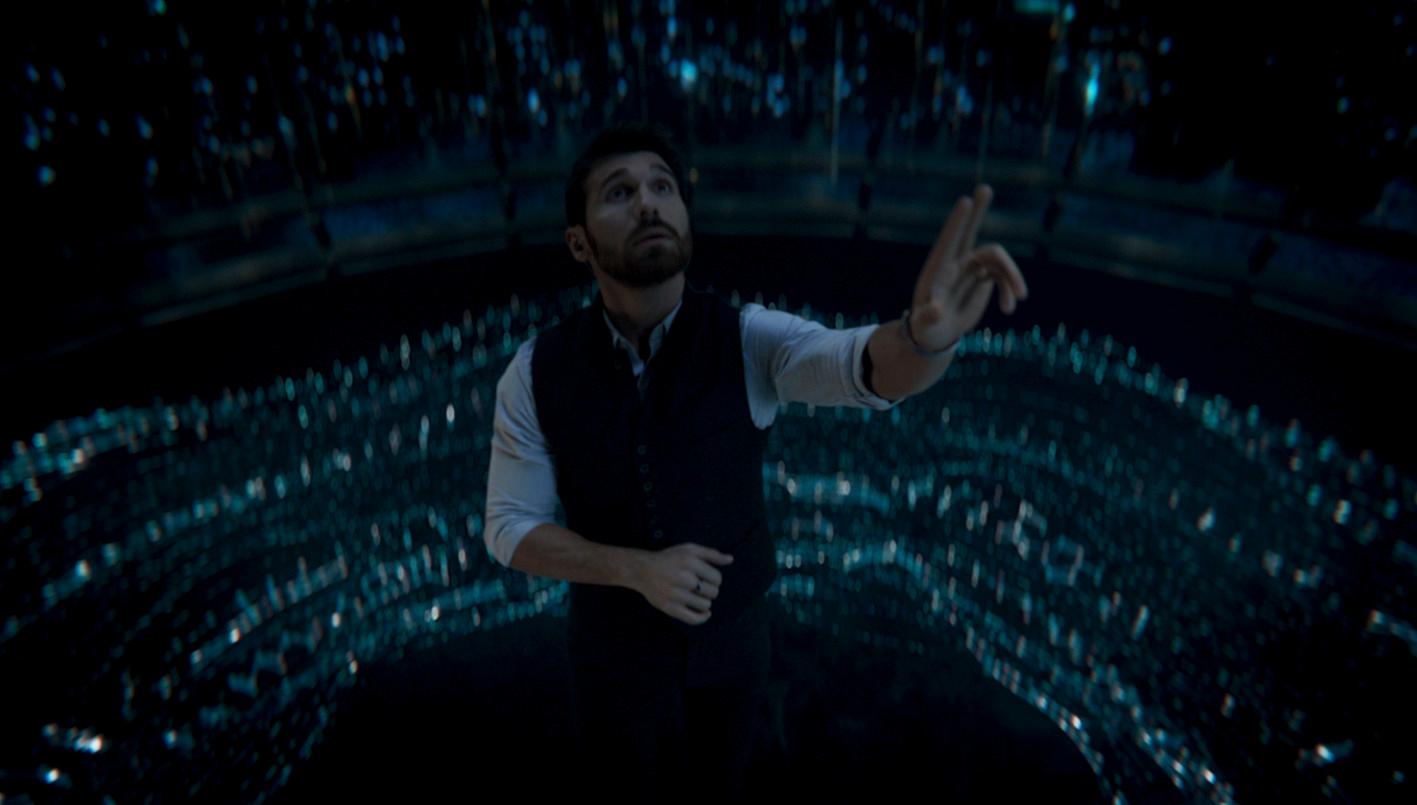 a man standing in front of a wall of lights