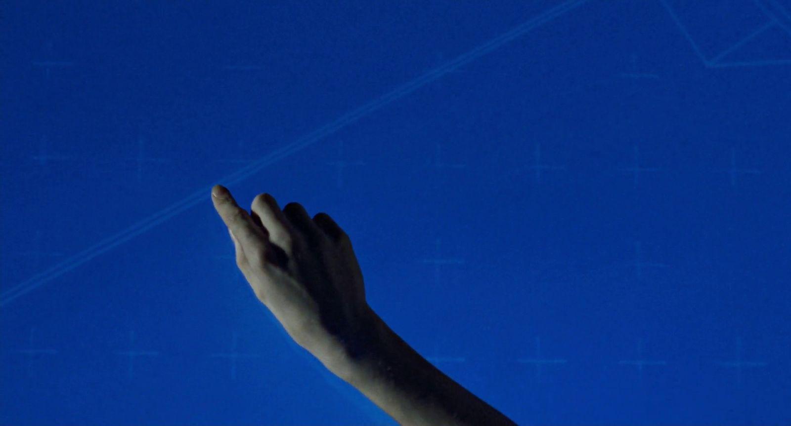 a person's hand reaching up into the sky