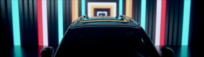 a car parked in front of a multicolored wall