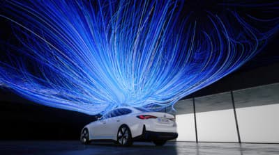 a car parked in front of a building with blue lights