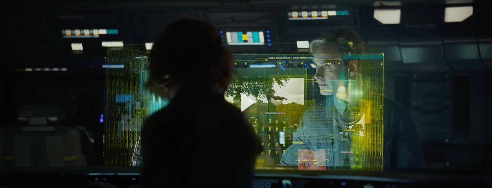 a woman standing in front of a computer screen
