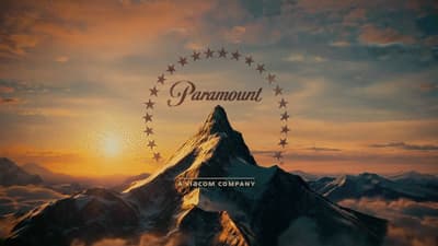 a picture of a mountain with the sun setting behind it