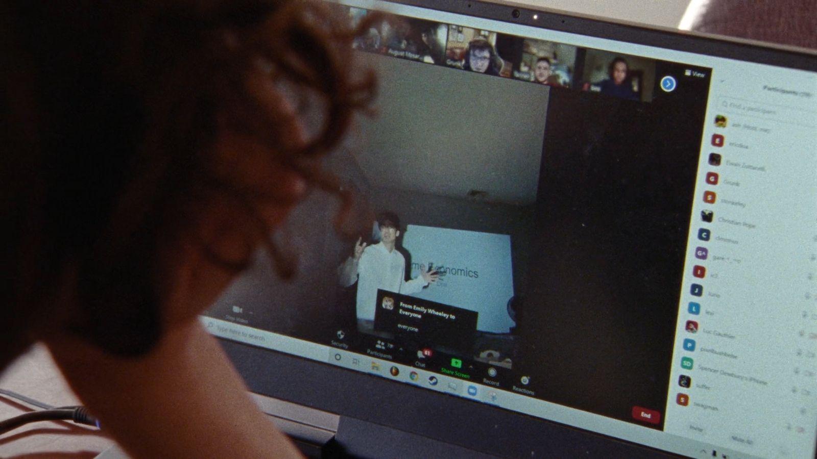 a person sitting in front of a computer monitor