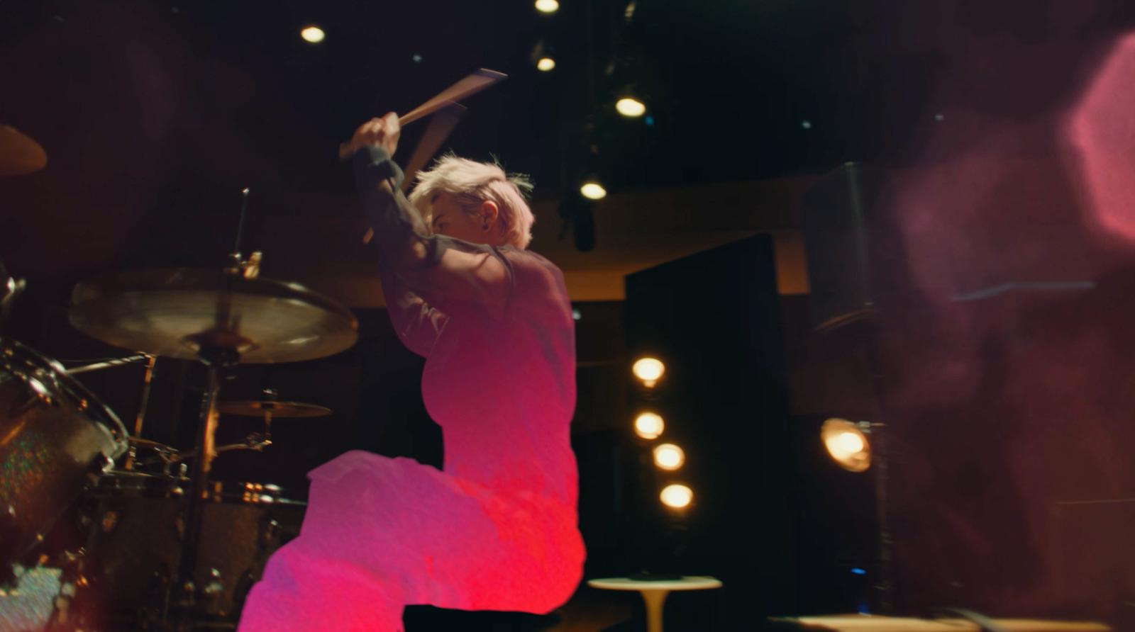 a woman in a pink dress is on stage