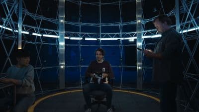 a man sitting in a chair in front of another man