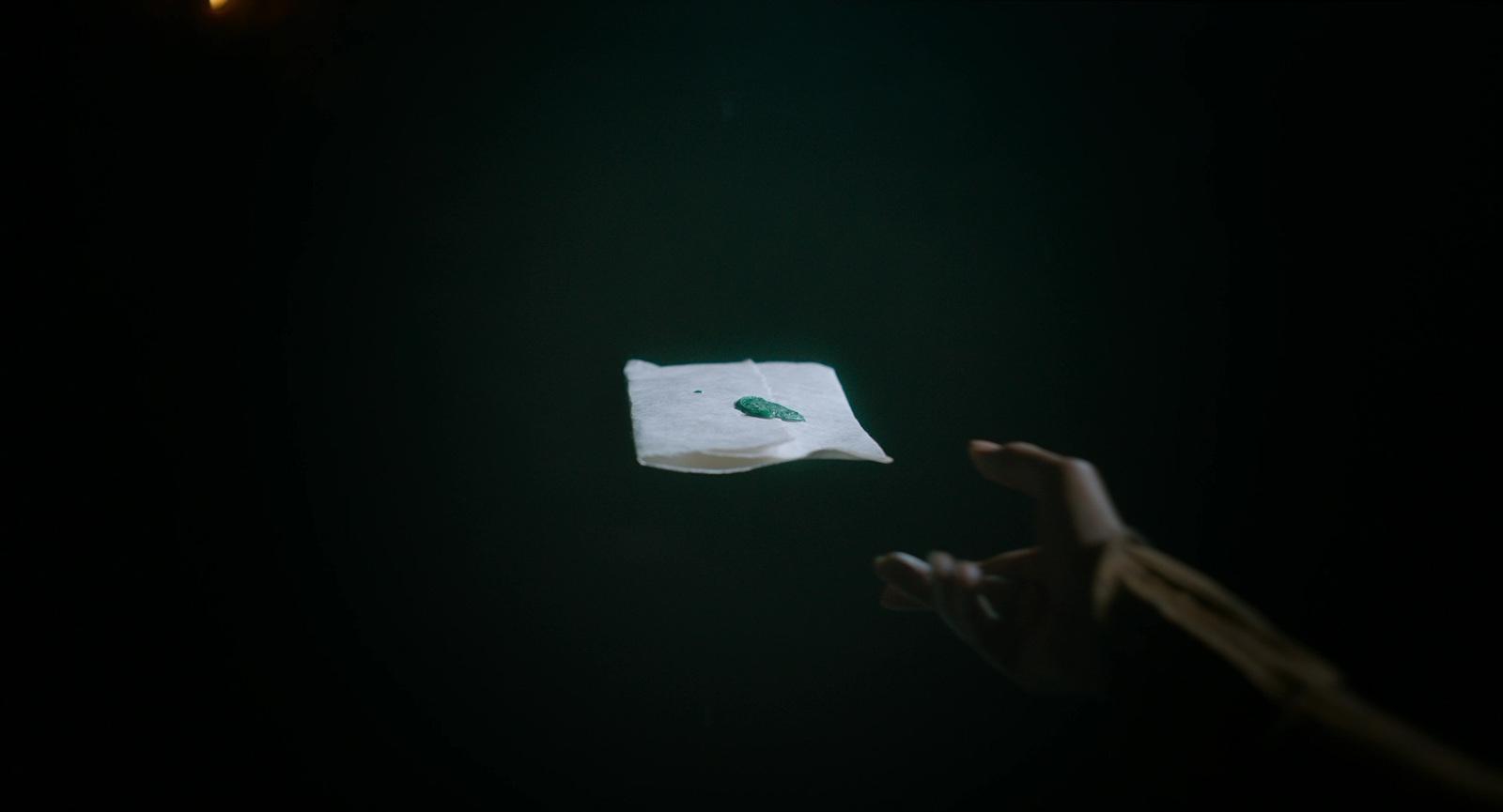 a person holding a piece of paper in the dark