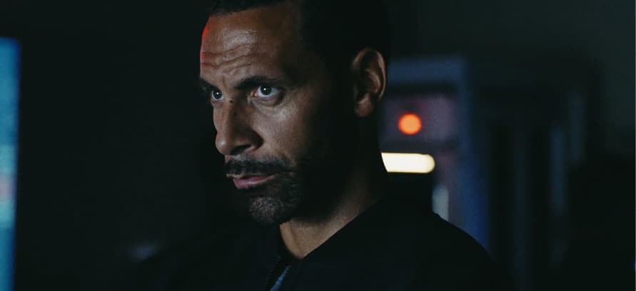 a man in a black shirt is staring at the camera