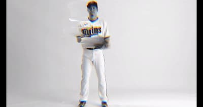a man in a baseball uniform holding a baseball bat
