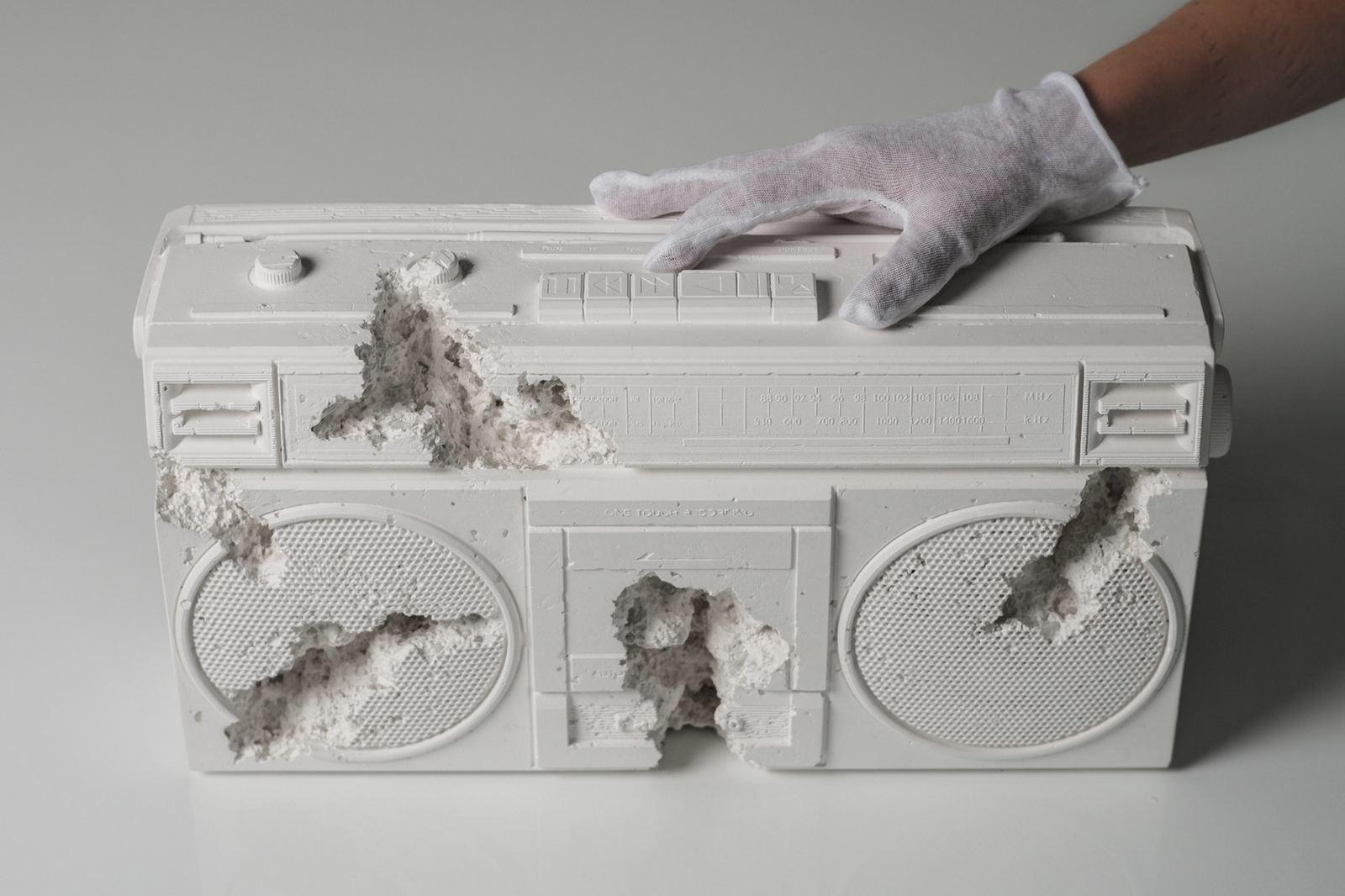 a person in white gloves is holding a radio