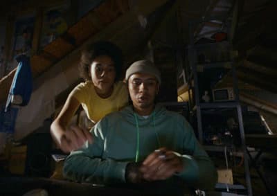 a man and a woman sitting in a dark room
